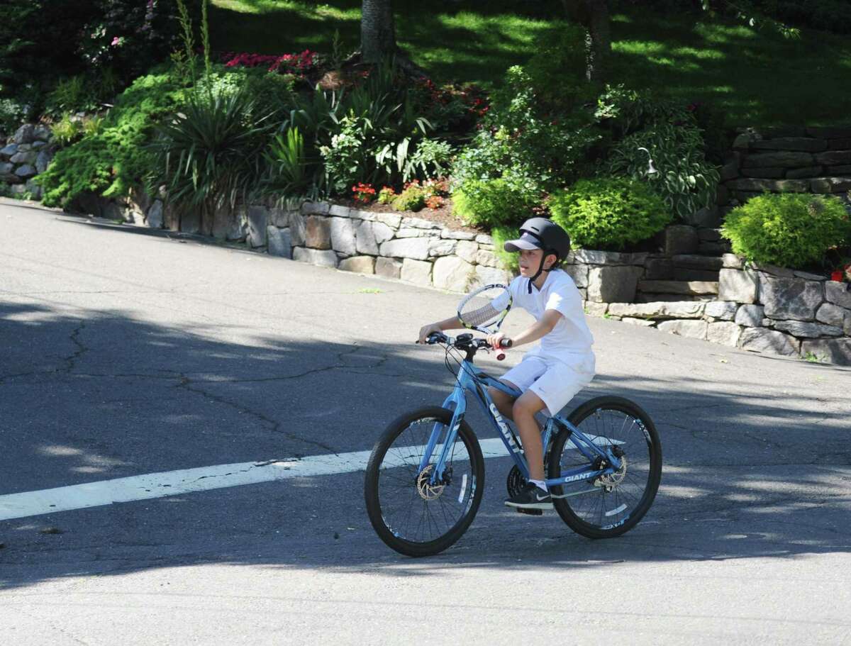 A boy rides his bike on the street near Binney Park in Old Greenwich, Conn. Monday, June 25, 2018. A new study, led by a researcher from the Center for Injury Research and Policy at the Nationwide Children?’s Hospital in Ohio, has released new statistics on bicycle accidents involving children. Click through the slideshow to read more. 