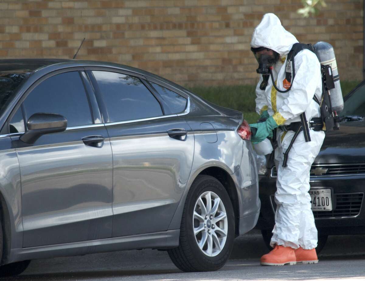 Hazardous material crews hepl investigate the scene where a fentanyl-laced flyer was found on the windshield of a Harris County Sheriff's Office vehicle Tuesday, June 26, 2018.