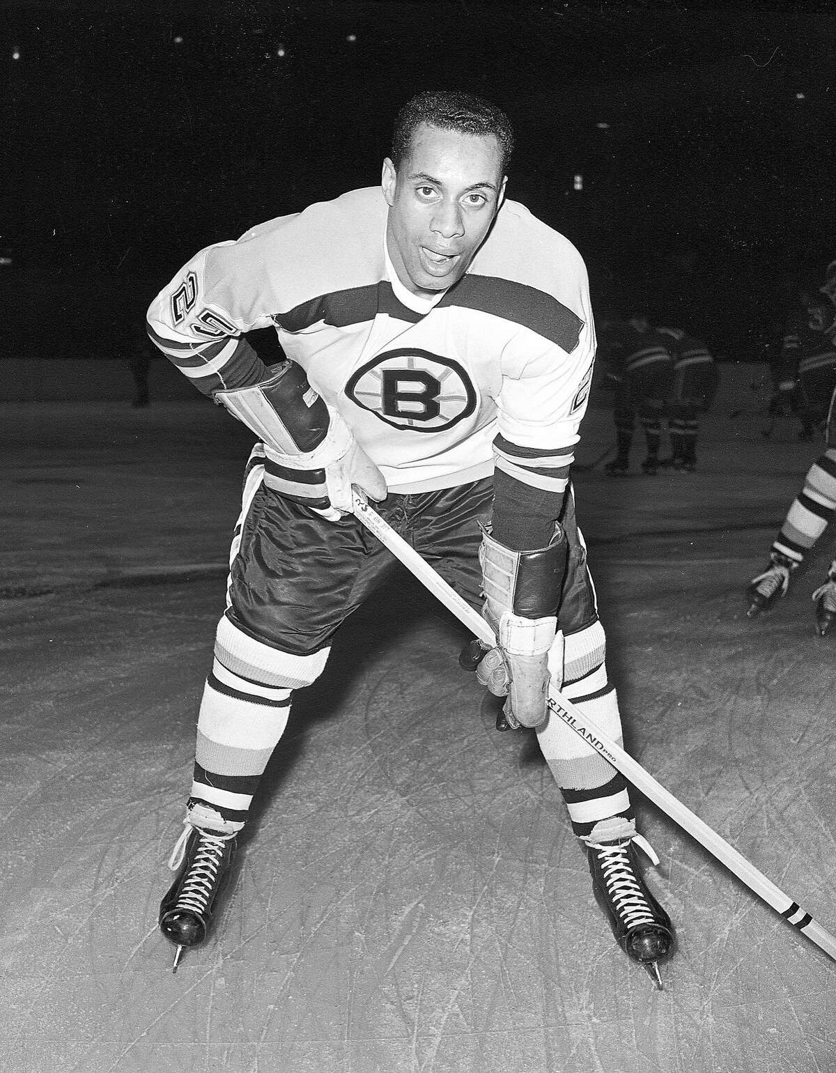 FILE - In this Nov. 23, 1960, file photo, 25-year-old left wing Willie O'Ree, the first black player of the National Hockey League, poses for a photo as he warms up in his Boston Bruins uniform prior to an NHL hockey game with the New York Rangers at New York's Madison Square Garden. O'Ree was selected to the Hockey Hall of Fame, Tuesday, June 26, 2018. (AP Photo, File)