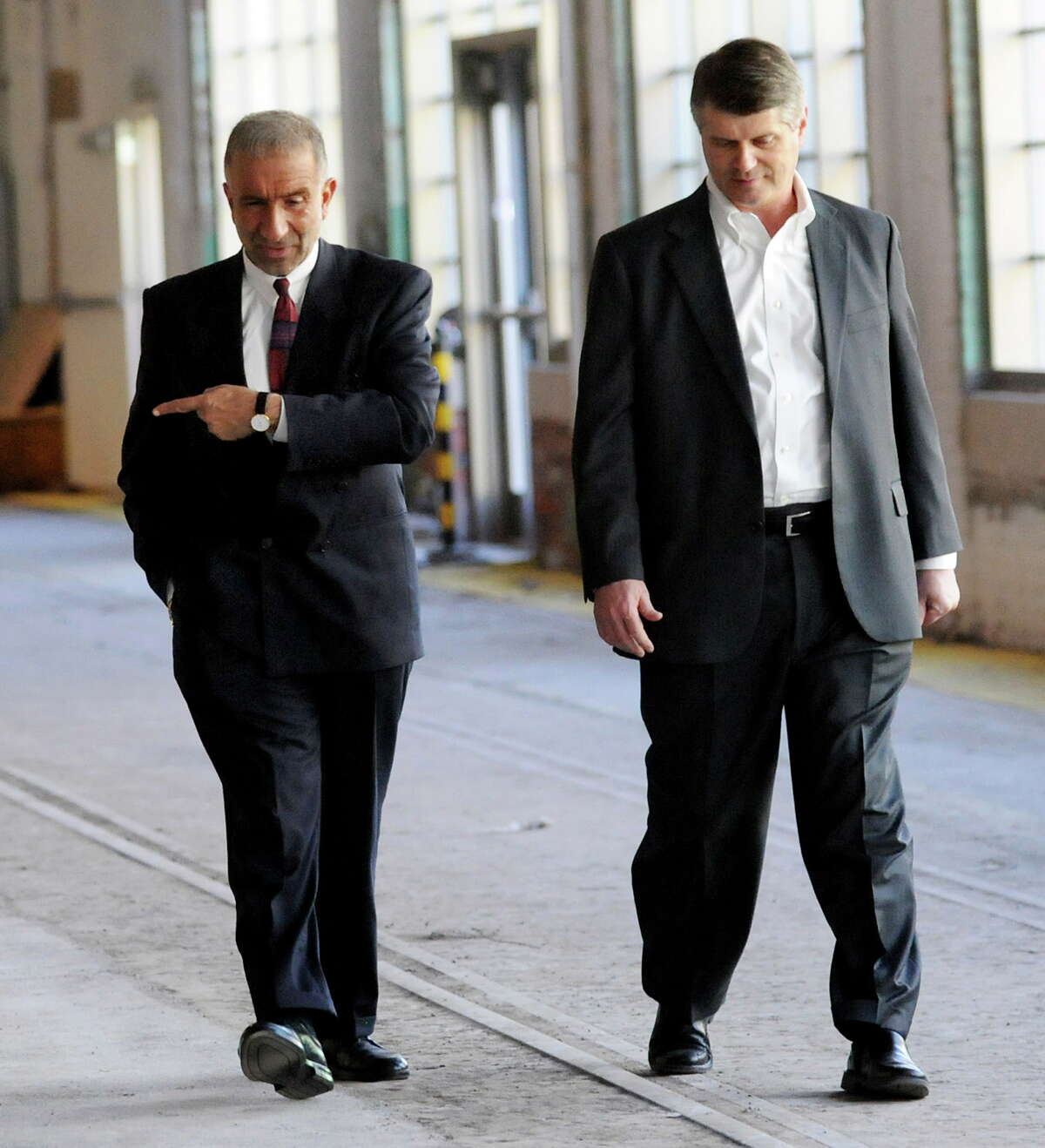 Alain E. Kaloyeros, senior vice president and CEO of the College of Nanoscale Science and Engineering, left, and Rick Whitney, CEO of M + W Group, walk through an yet to be developed area in the Watervliet Arsenal on the way to the new headquarters of M + W on Thursday, Aug. 4, 2011, in Watervliet, N.Y. (Cindy Schultz/Times Union archive)