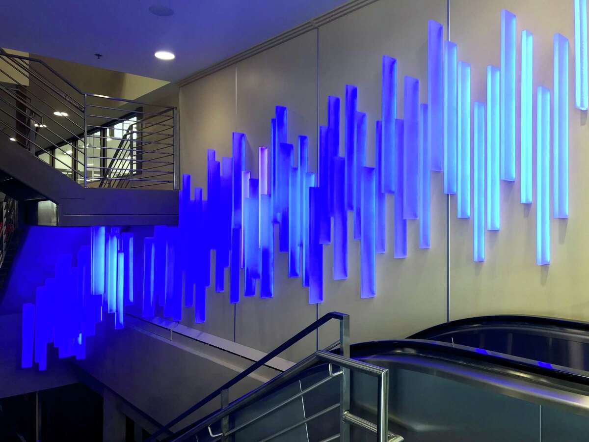 San Antonio artist Ansen Seale’s “Blue By You,” a light installation that changes as people pass below it on the escalator, greets visitors as they enter H-E-B’s new Bellaire, Texas store.