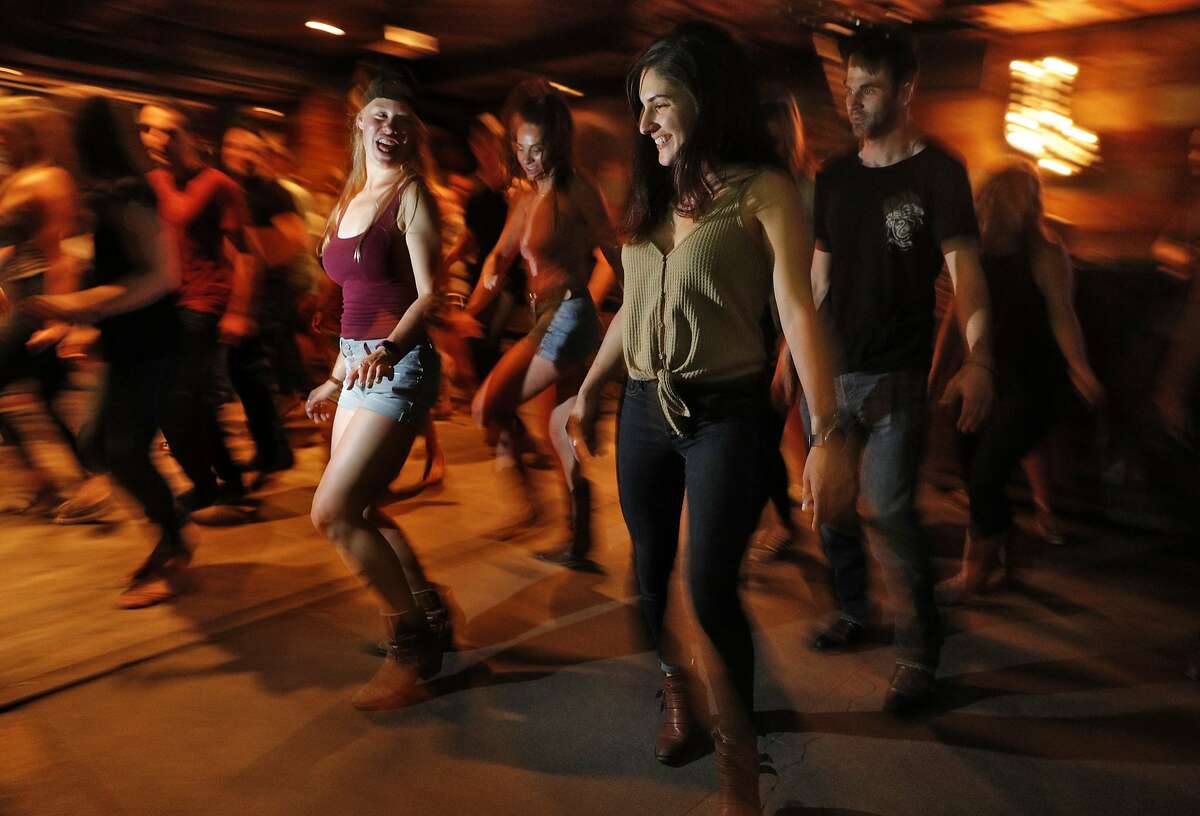 Patrons dance during weekly line dancing lessons at Jaxson, a bar in the Marina that specializes in country music, in San Francisco, Calif., on Sunday, June 24, 2018.