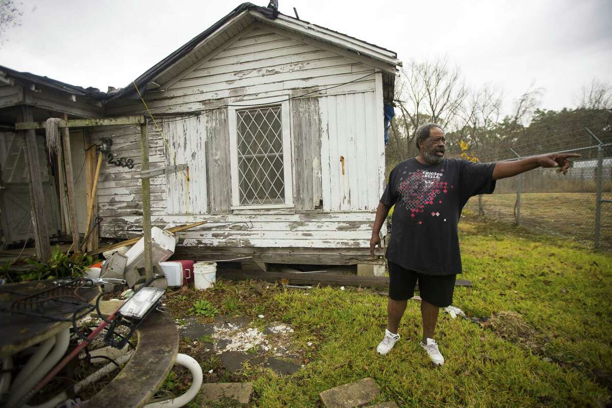 Herman Smallwood walks in front of his damaged Aldine home, Thursday, Jan. 11, 2018. Smallwood, whose house had been previously damaged when a tree feel on the house, suffered extensive additional roof and foundation damage from Hurricane Harvey. Smallwood was denied assistance from FEMA to repair his home and is currently appealing the process.