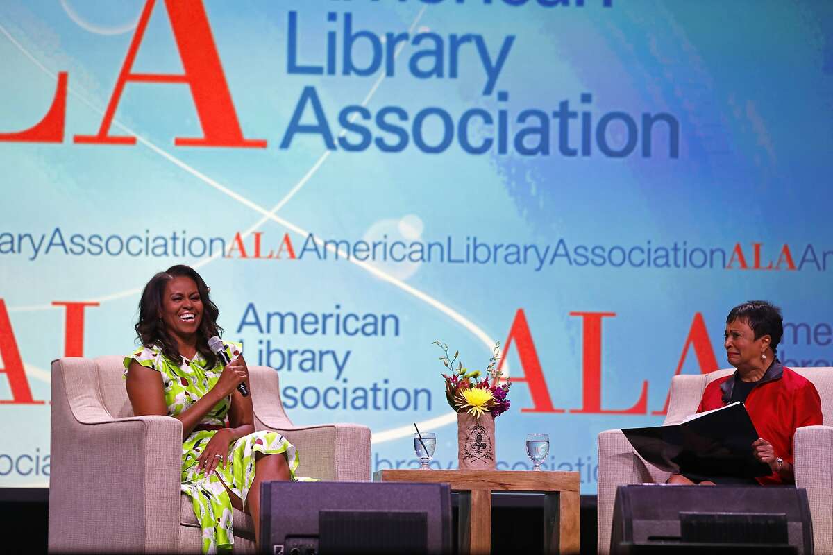 Former first lady Michelle Obama speaks with Librarian of Congress Dr. Carla Hayden, right, at the American Library Association annual conference in New Orleans, Friday, June 22, 2018. (AP Photo/Gerald Herbert)