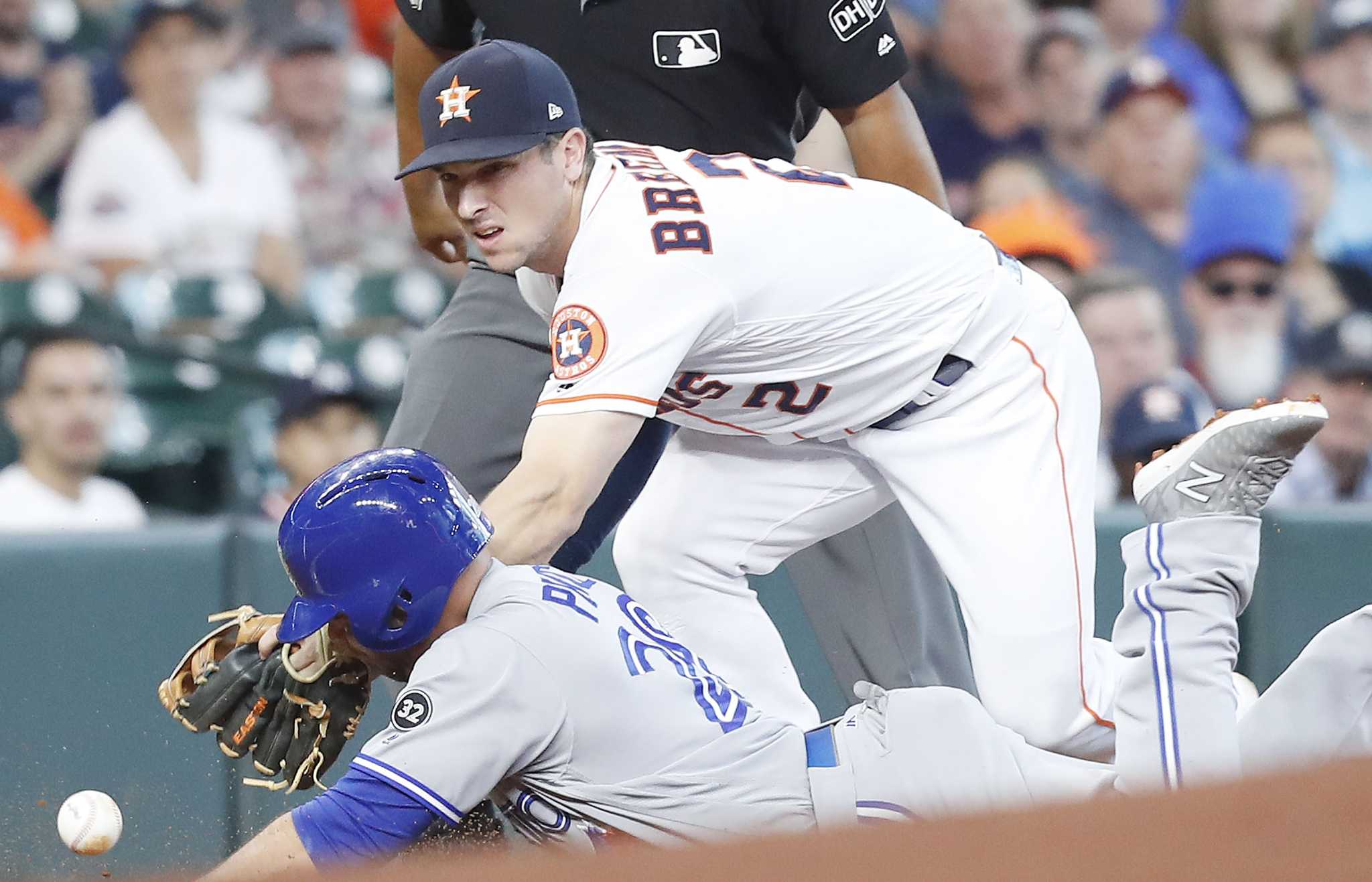 Toronto Blue Jays' Randal Grichuk reacts towards the Houston Astros' dugout  during a video replay of Grichuk being called safe at first during the  eighth inning of a baseball game against the