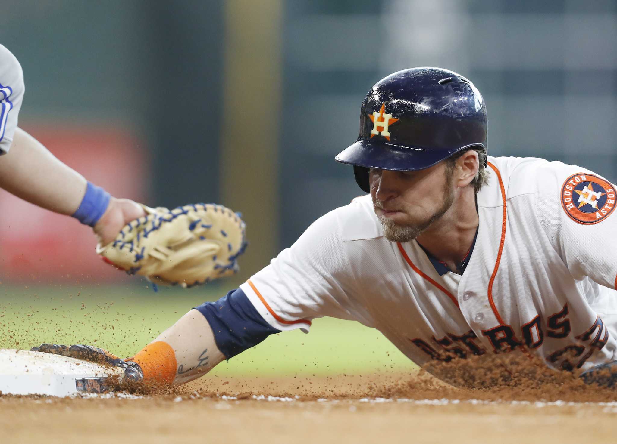 Toronto Blue Jays' Randal Grichuk reacts towards the Houston Astros' dugout  during a video replay of Grichuk being called safe at first during the  eighth inning of a baseball game against the