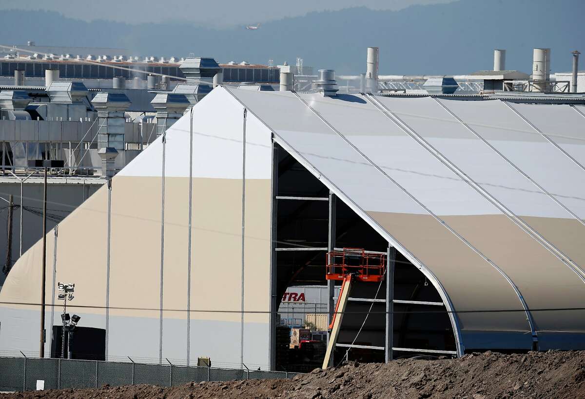 A large temporary building is erected in a back lot of the Tesla manufacturing plant in Fremont, Calif. on Wednesday, June 27, 2018. Tesla is assembling the new Model 3 sedan in the tent-like structure to meet demand and deadlines.