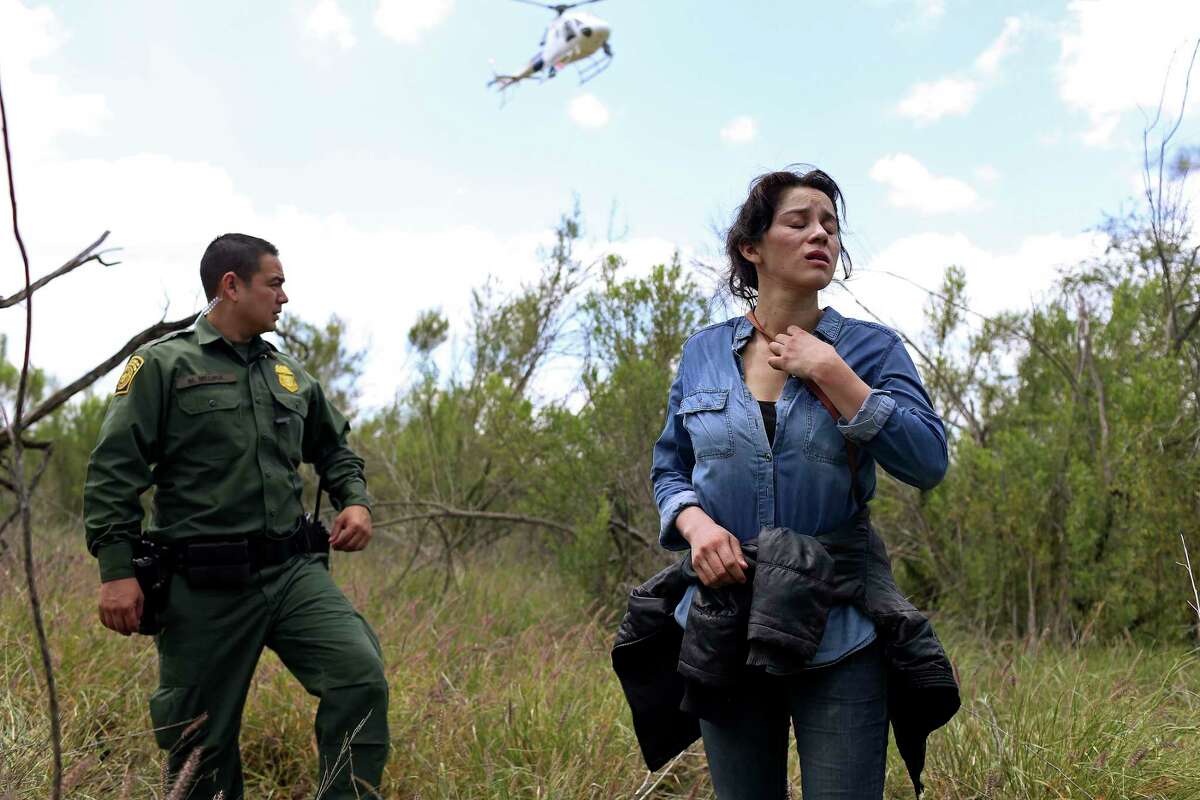 U.S. Border Patrol agent Marcelino Medina detains Veronica Reyes, 26, of Veracruz, Mexico, near the Anzalduas International Bridge in Mission, Texas, Thursday, May 10, 2018. Reyes was with a group of five immigrants attempting to enter the U.S. illegally. The rest were able to cross back into Mexico and escape detention.