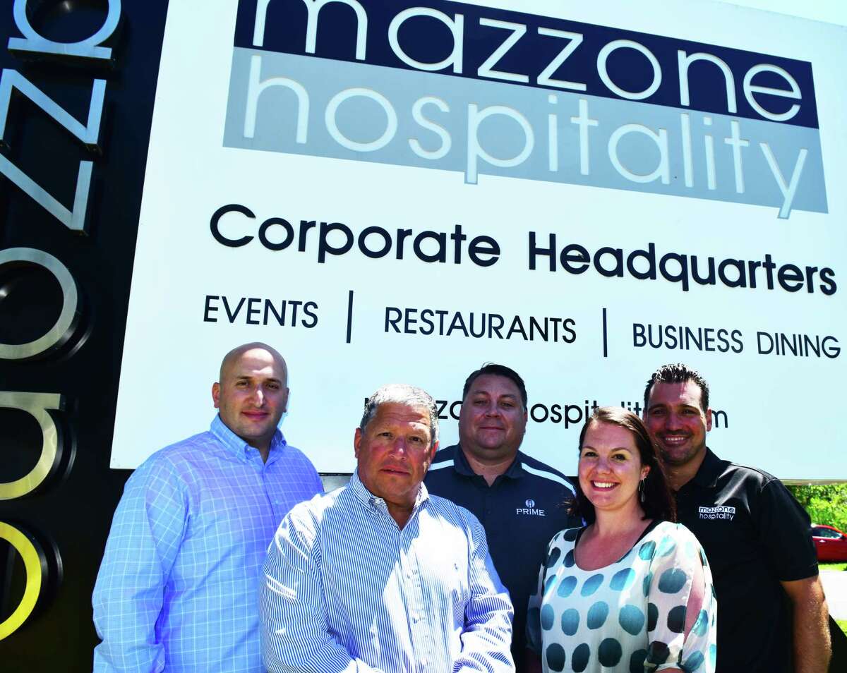 From left, Matt Mazzone, chief financial officer of Mazzone Hospitality; founder and president Angelo Mazzone; Tim Vennard, vice president of business dining; human resources director Justine Ochal; and Sean Willcoxon, regional vice president of catering, outside the compay's Clifton Park headquarters on Monday June 25, 2018. (Steve Barnes/Times Union.)
