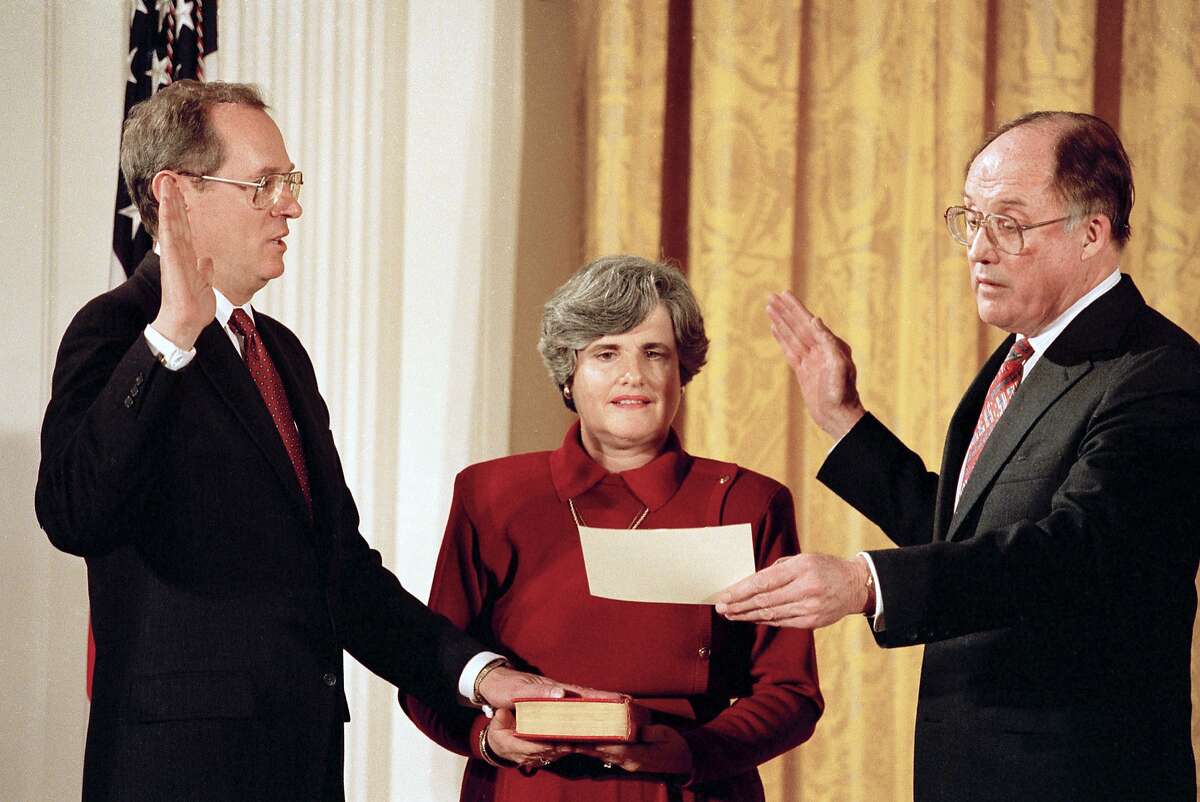 FILe - In this Feb. 18, 1988, file photo Anthony Kennedy, left, takes the constitutional oath as a Supreme Court Associate Justice from Chief Justice William Rehnquist at a White House ceremony in Washington. Holding the Bible is Kennedy's wife, Mary Kennedy. The 81-year-old Kennedy said Tuesday, June 27, 2018, that he is retiring after more than 30 years on the court. (AP Photo/Doug Mills, File)