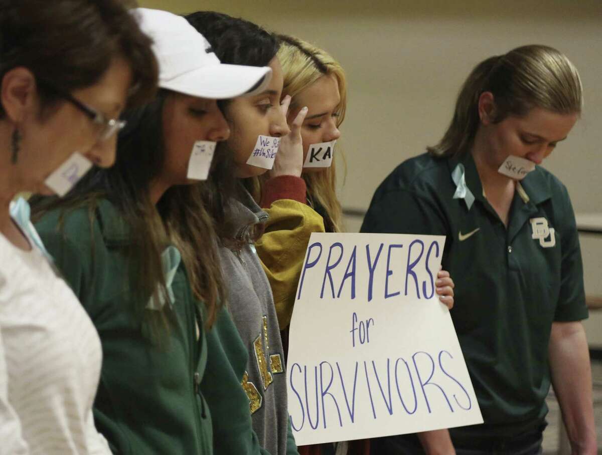 In this June 3, 2016 photo, current and former Baylor students hold a rally warning of sexual assaults on and off campus in Waco.