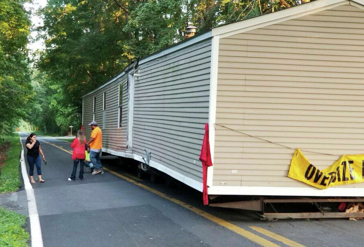 This June 26, 2018 photo image provided by the Dover Delaware Police Department shows a prefabricated home that was abandoned on a roadway in Dover, Del. Dover Police Department said someone left a home on a two-lane road and no one was available to move it until Wednesday, June 27. (Dover Delaware Police Department via AP)