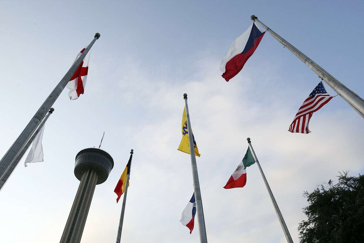 The Tower of the Americas is pictured between flags during the 39th Texas Folklife Festival in 2010 at the Institute of Texan Cultures.