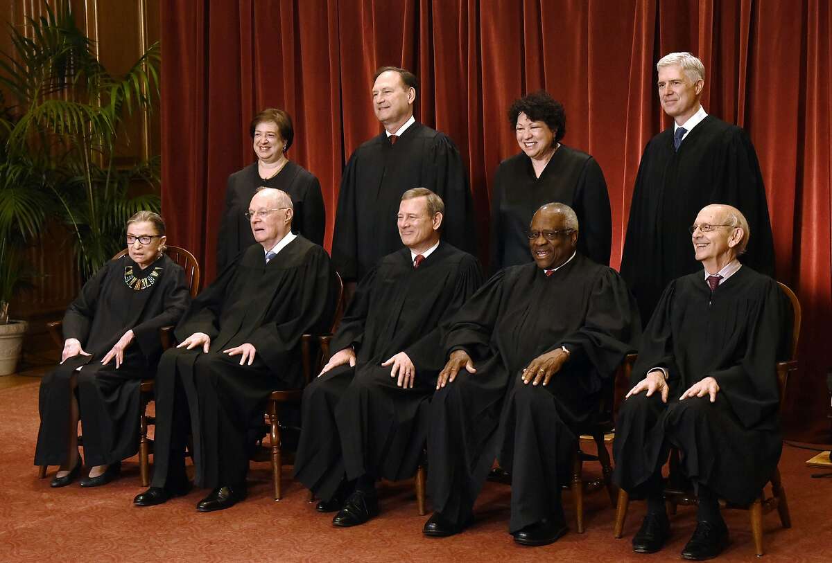 Members of the U.S. Supreme Court pose for a group photograph at the Supreme Court building on June 1, 2017, in Washington, D.C.