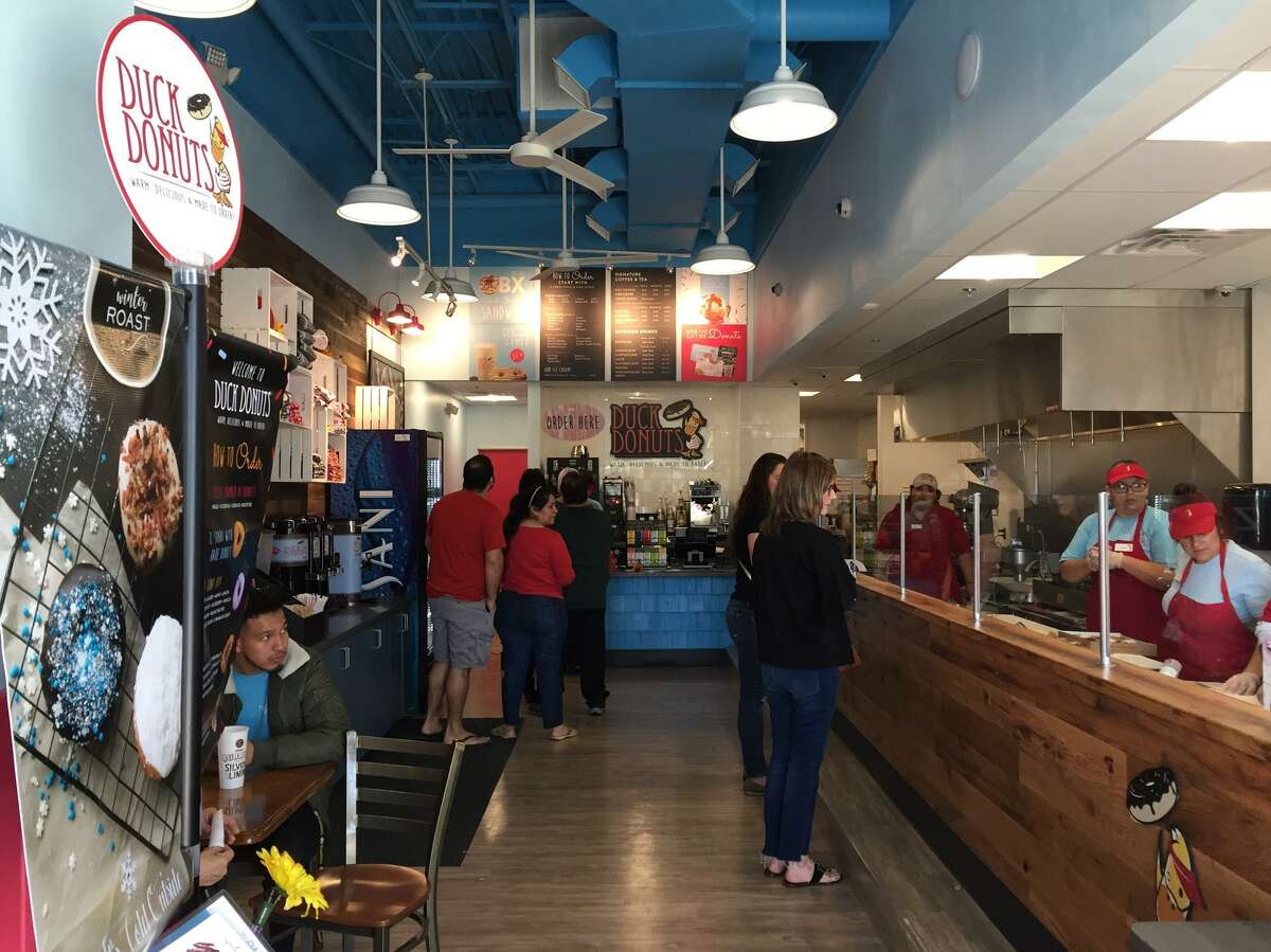 Customers line up for fresh customized doughnuts at Duck Donuts.