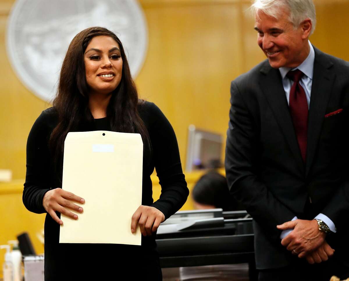 Gabrielle smiles after receiving her graduation certificate from District Attorney George Gascon during San Francisco Collaborative Courts' Young Adult Court Graduation Ceremony at Hall of Justice in San Francisco, Calif. on Wednesday, June 20, 2018.