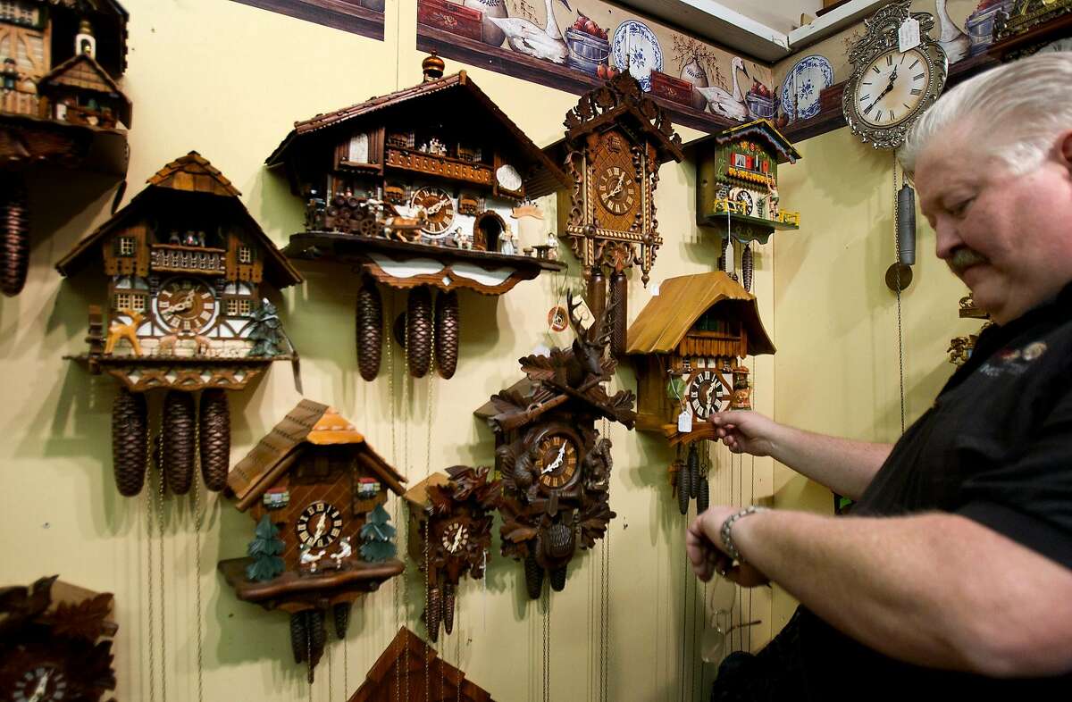 Kevin Moore sets a clock at Moore Time clocks Friday, March 8, 2013, in Old Town Spring. "We have over 1,000 chiming clocks," Moore said. "If they're all going off at the same time, the building would shake." (Cody Duty / Houston Chronicle)