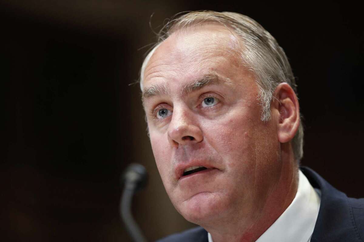 FILE - In this May 10, 2018, file photo, Interior Secretary Ryan Zinke testifies at a Senate Appropriations subcommittee hearing on the FY19 budget, on Capitol Hill in Washington. Interior Secretary Ryan Zinke's family is involved in a land deal with the head of an energy services giant that has business with the Interior Department. Politico first reported the Zinkes' dealings with Halliburton chairman David Lesar for a planned commercial development in Zinke's hometown of Whitefish, Mont. (AP Photo/Jacquelyn Martin, File)