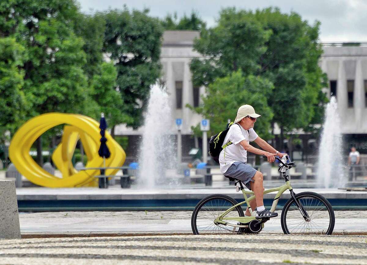 A man rides his bicycle through the Empire State Plaza Thursday June 28, 2018 in Albany, NY. (John Carl D'Annibale/Times Union)
