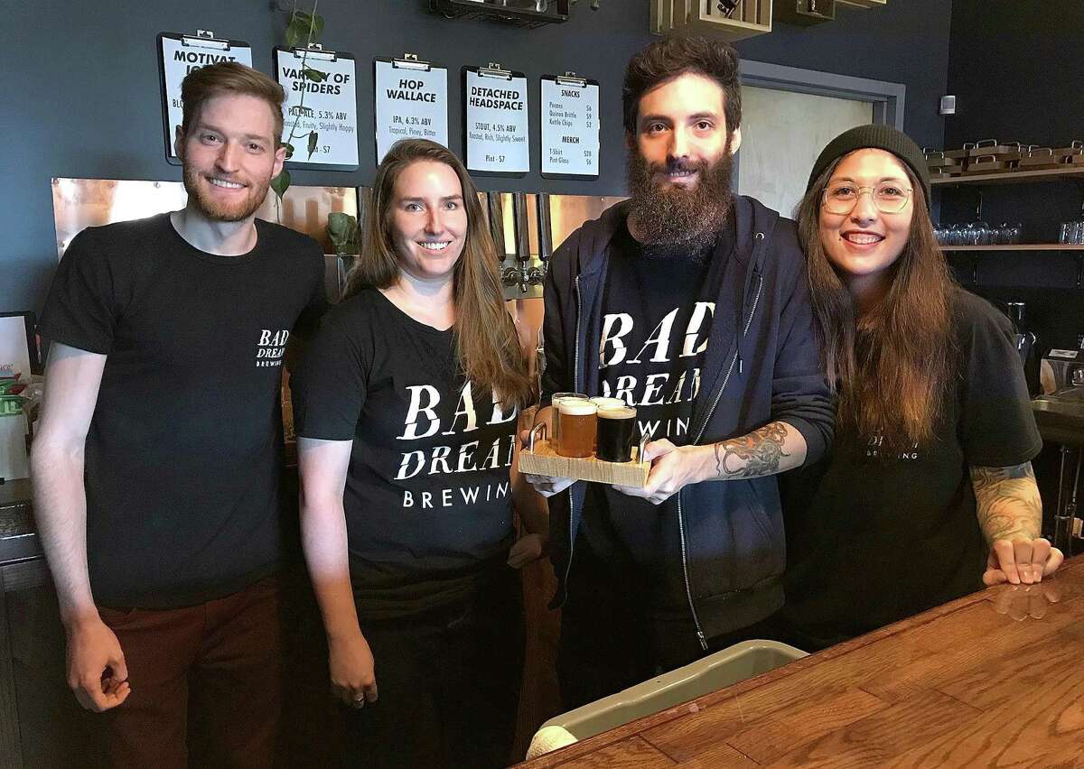 Bad Dream Brewing owners Brian Benzinger, Emily Leone, Max Retter and Michelle Retter stand behind the bar at their newly opened taproom at 116 Danbury Road (Route 7) in New Milford on Thursday.