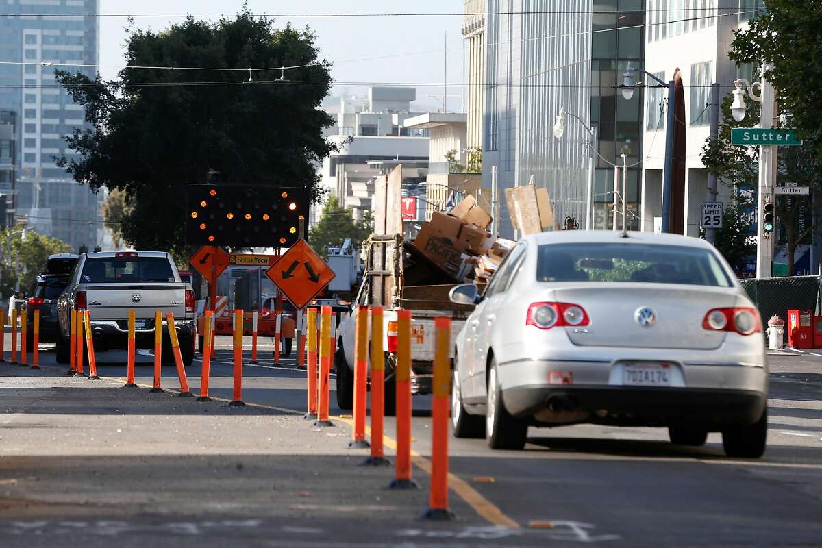 Traffic is rerouted through a construction zone during work on express bus lanes on Van Ness Avenue in San Francisco in June 2018.