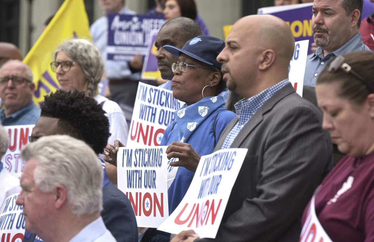 Tracy Carter, center, of Hartford, a member of the Hartford Federation of Paraprofessionals, AFT Local 2221, during a news conferenceon the steps of the state Supreme Court on Wednesday in response to the U.S. Supreme Court ruling on Janus v. AFSCME Council.