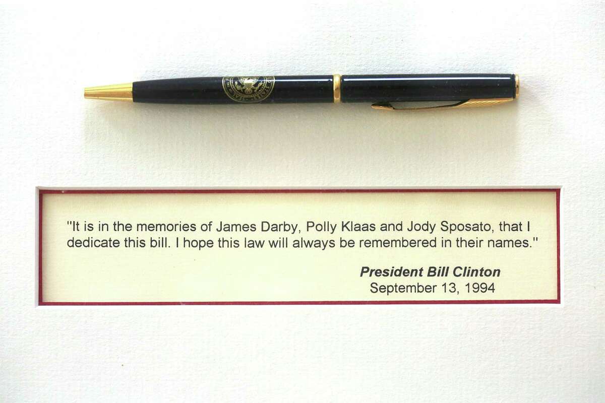 Stephen Sposato shows pen given to him by president Clinton after the passing of the 1994 Federal Assault Weapons Ban (AWB) which he shows in his living room on Thursday, June 14, 2018 in Lafayette, Calif. President Clinton mentions Sposato's significant role in passage of assault weapons ban as he listened to Stephen talk of his tragedy while holding his child Meghan beside him.