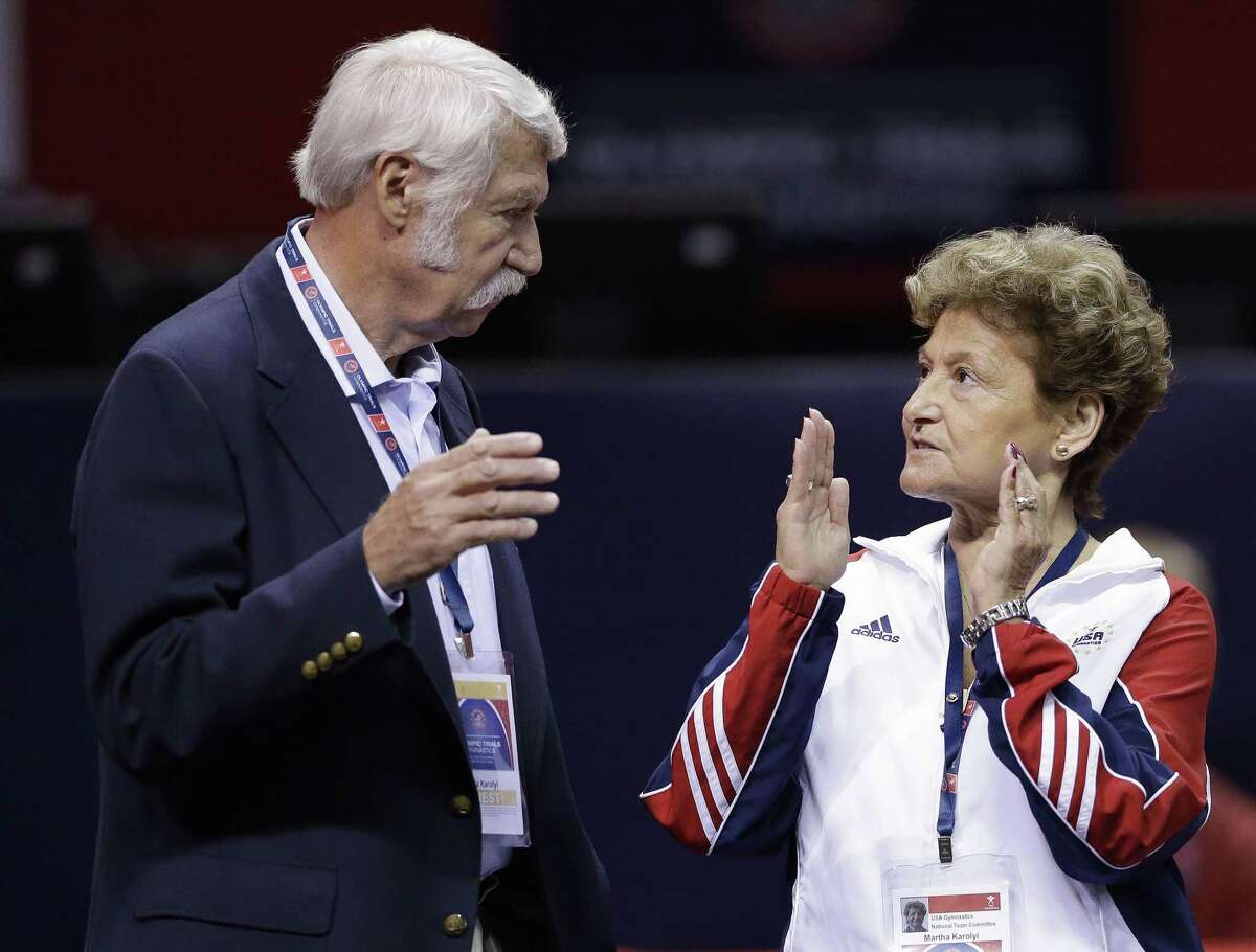 FILE - In this June 29, 2012, file photo, Bela Karolyi, left, and his wife, Martha Karolyi, talk on the arena floor before the start of the preliminary round of the women's Olympic gymnastics trials in San Jose, Calif. Investigators in Texas on Friday, June 29, 2018, are expected to address allegations of criminal behavior by disgraced former sports doctor Larry Nassar at the famed gymnastics training center in Texas that was run by the Karolyis. The facility has since closed and Nassar has been imprisoned for life. (AP Photo/Gregory Bull, File)