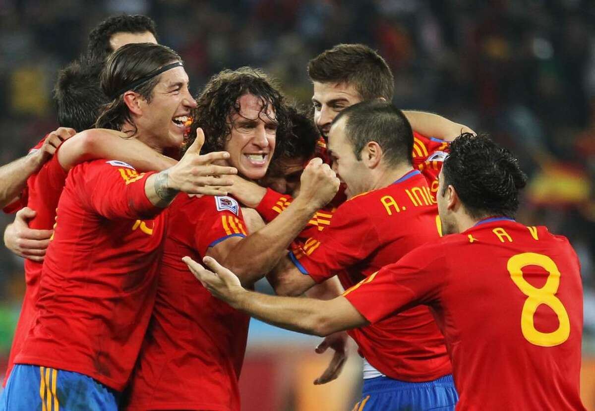 DURBAN, SOUTH AFRICA - JULY 07: Spain team mates celebrate the opening goal scored by Carles Puyol during the 2010 FIFA World Cup South Africa Semi Final match between Germany and Spain at Durban Stadium on July 7, 2010 in Durban, South Africa. (Photo by Joern Pollex/Getty Images) *** Local Caption *** Carles Puyol