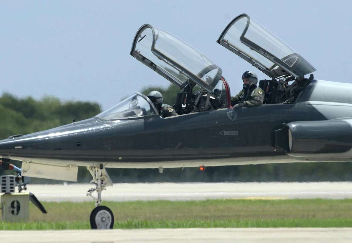 A T-38 Talon jet trainer crew taxis alongside a runway at Joint Base San Antonio-Randolph.