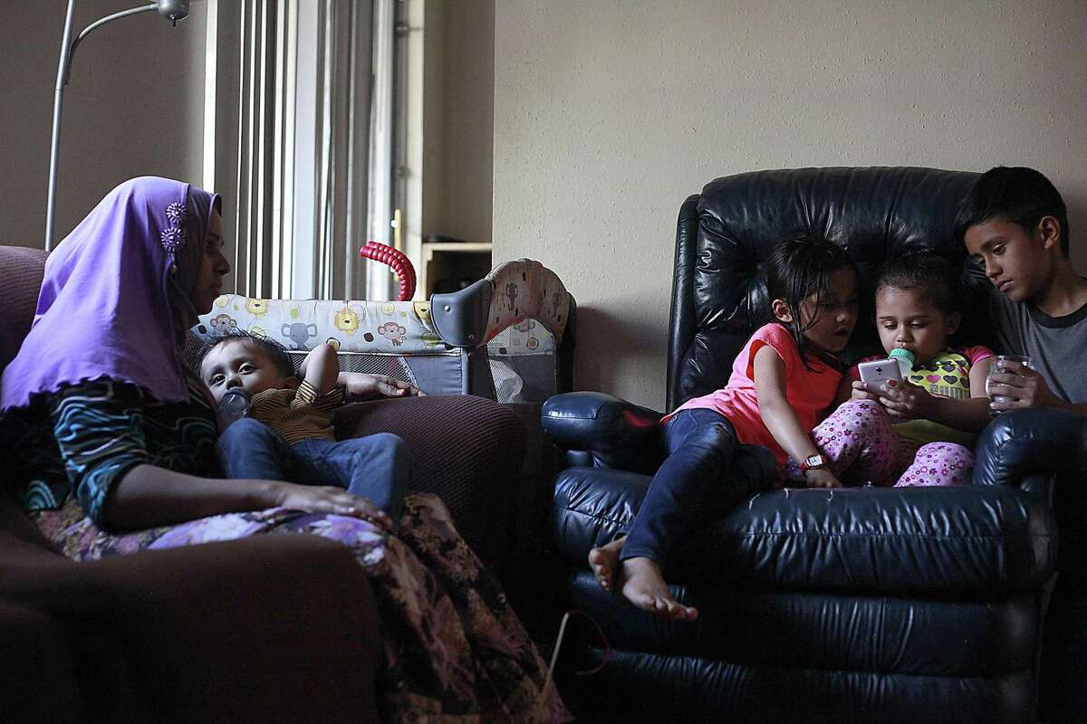 Saidah Binti Yasin 28, (left), a recent immigrant from Malaysia spends her Tuesday afternoon with her children. Saidah said she enjoys being in the U.S. but wishes the condition of the apartment she stays in was better.
