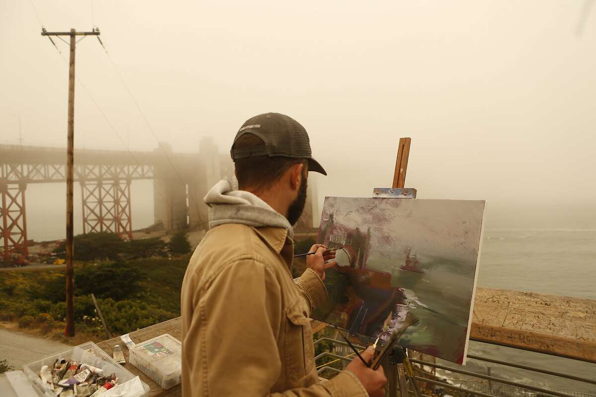 Andrew Walker Patterson, a professor of art from Redding Calif, paints the Golden Gate Bridge on Sunday, July 1, 2018 in San Francisco, Calif. Air quality in and around San Francisco has been visibly affected by the fires through the weekend. Patterson is on summer break and will be traveling around painting for the month of July.