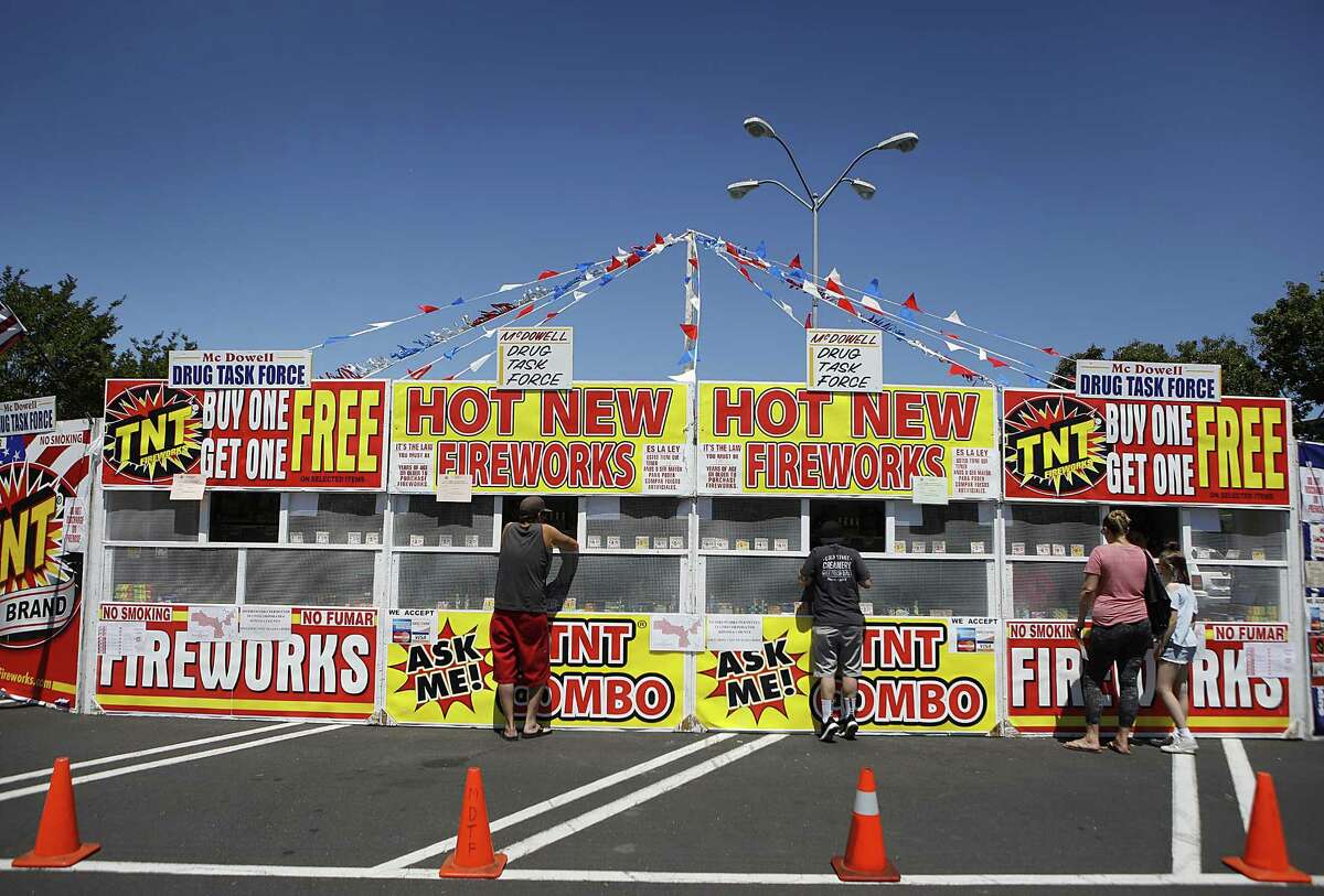 Customers shop at the McDowell Drug Task Force stand in Petaluma, where “safe and sane” fireworks are legal.