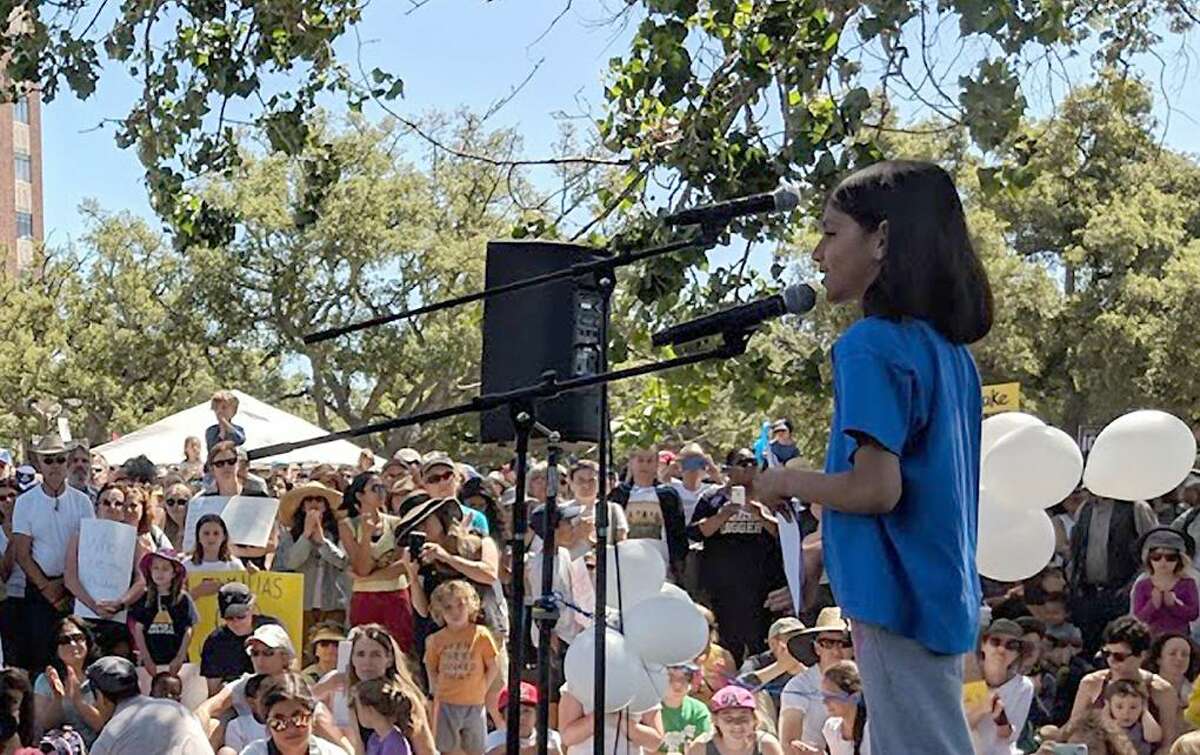 Kaia Marbin speaks at the Families Belong Together rally Saturday in Oakland. Kaia decided to hold the event after she saw a viral photo of an immigrant child and her mother.
