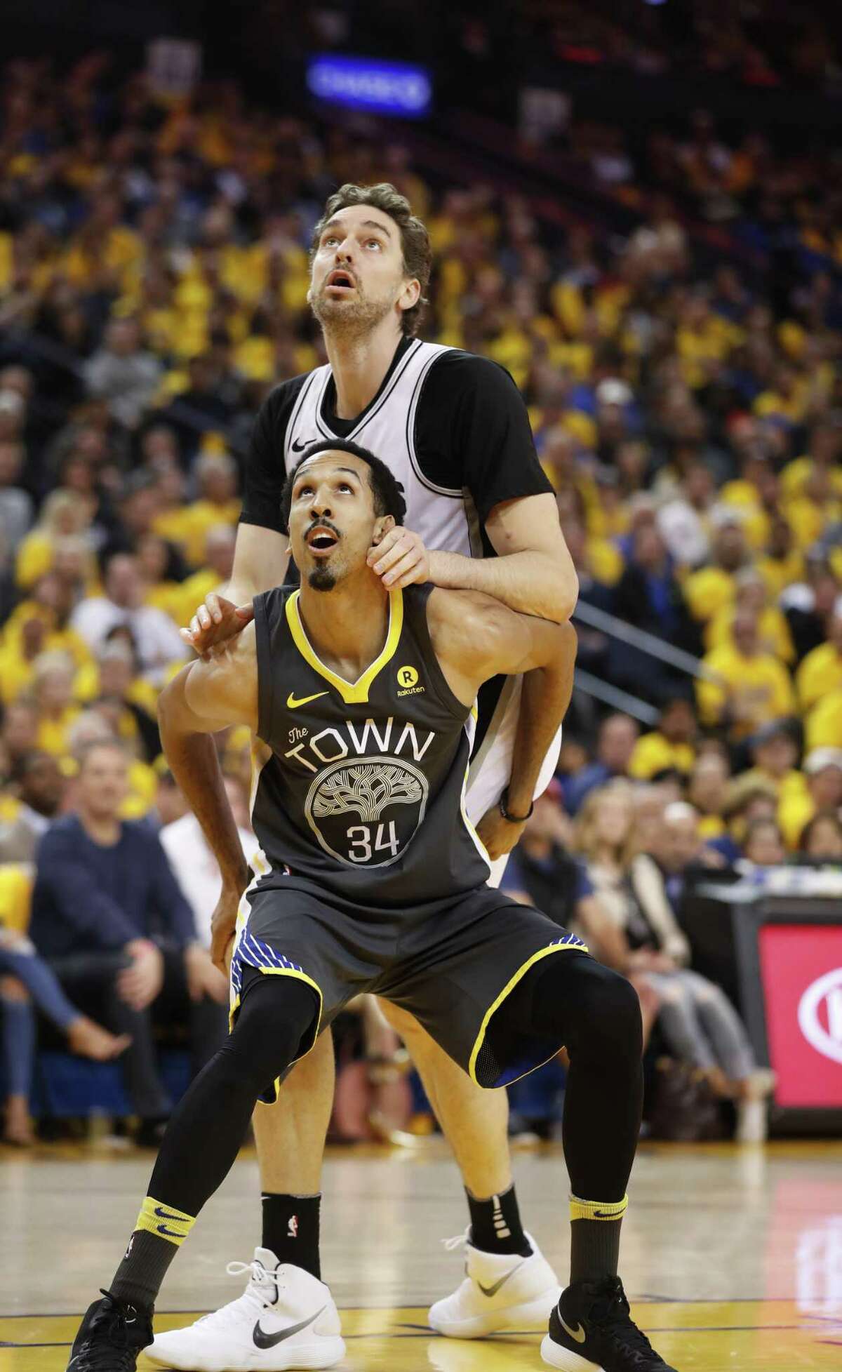 Golden State Warriors' Shaun Livingston and San Antonio Spurs' Pau Gasol fight for rebound position in the first quarter during game 2 of round 1 of the Western Conference Finals at Oracle Arena on Monday, April 16, 2018 in Oakland, Calif.