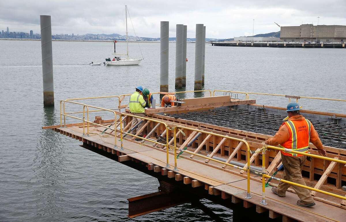 Construction workers build a new ferry terminal near the old Ford assembly plant and Craneway Pavilion in Richmond, Calif. on Tuesday, May 15, 2018. The terminal is expected to boost the number of commuters and visitors to the area when ferry service begins in the fall.