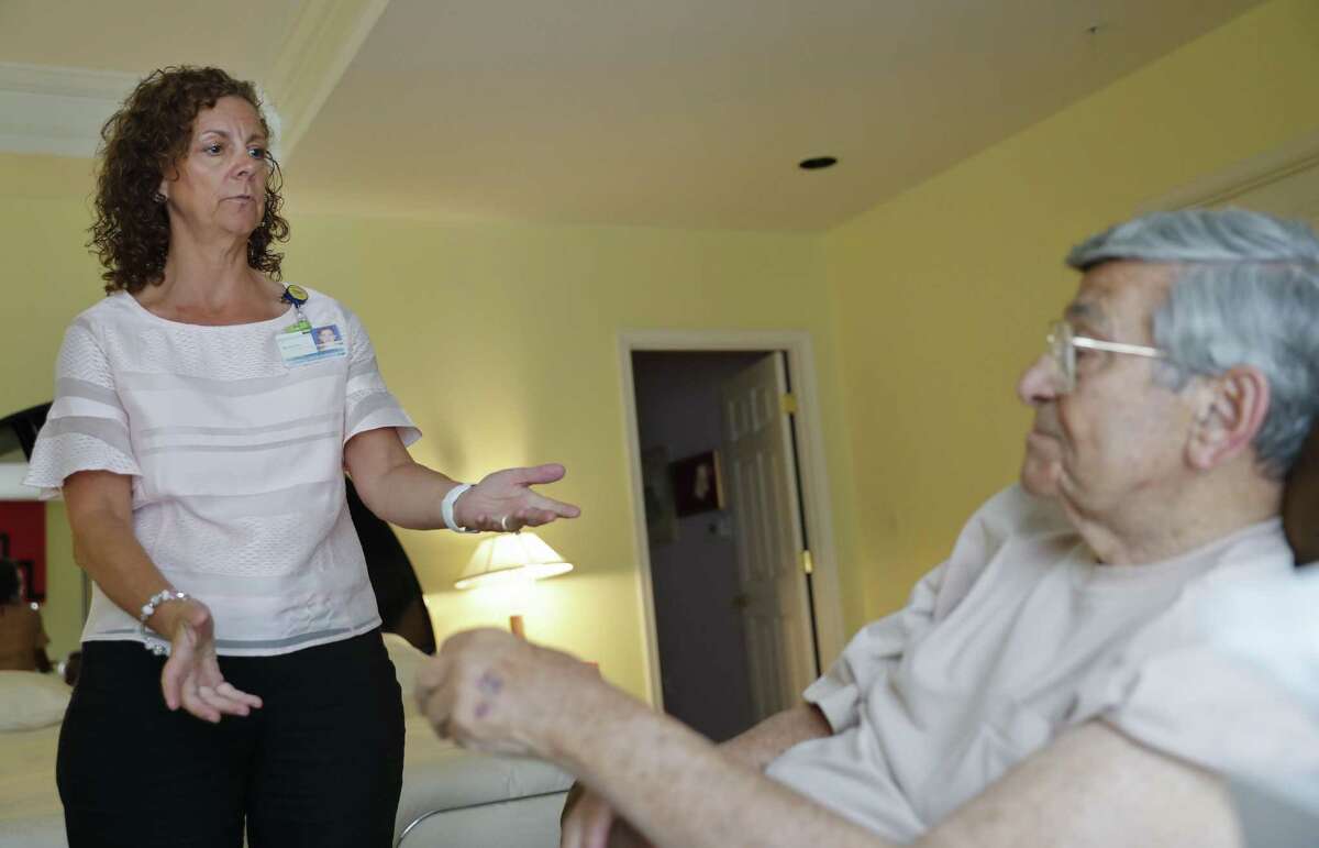 Nurse Melissa Lantz-Garnish, left, from Johns Hopkins Medicine, talks with her patient, 92 year-old Sidney Kramer, about using the remote medical monitoring system to check his vital signs in Bethesda Md. Nearly 9 in 10 would be comfortable using at least one type of telemedicine for themselves or an aging loved one.