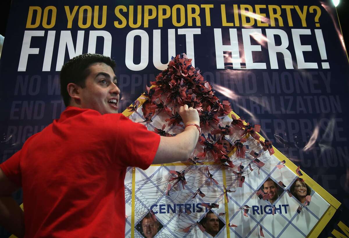 NATIONAL HARBOR, MD - FEBRUARY 28: Anthony Rodriguez of Young Americans for Liberty helps attendees to flag an unofficial poll of the "political climate of CPAC" during the last day of the 42nd annual Conservative Political Action Conference (CPAC) February 28, 2015 in National Harbor, Maryland. Conservative activists attended the annual political conference to discuss their agenda. (Photo by Alex Wong/Getty Images)