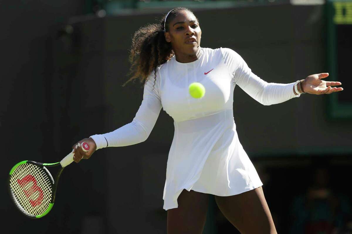 Serena Williams of the US returns a ball to Arantxa Rus of the Netherlands during the Women's Singles first round match at the Wimbledon Tennis Championships in London, Monday July 2, 2018. (AP Photo/Kirsty Wigglesworth)