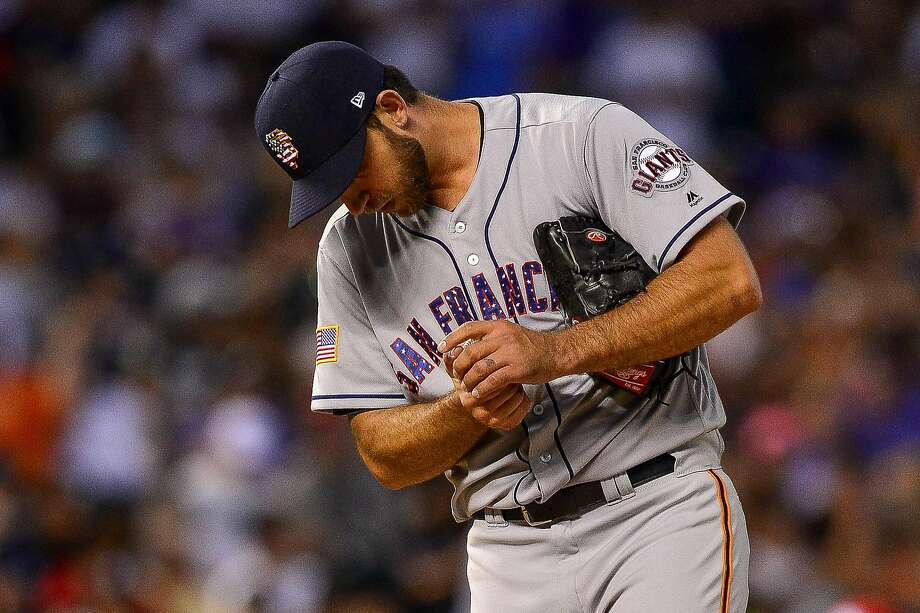   Madison Bumgarner # 40 of the San Francisco Giants takes a moment after letting the Colorado Rockies charge the bases at the seventh inning of a game at Coors Field on July 2, 2018 in Denver, Colorado. Photo: Dustin Bradford / Getty Images 