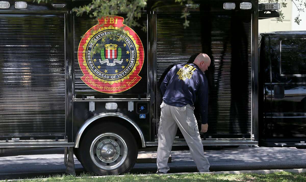A man wearing a shirt that reads "FBI Evidence Response Team" prepares to open a truck Wednesday April 26, 2017 in front of the building located at 415 Embassy Oaks in San Antonio. A placard in front of the building was identified with the word "Dannenbaum." According to the Laredo Morning Times website, the FBI has raided some city and county buildings in Laredo as well as Dannenbaum Engineering.
