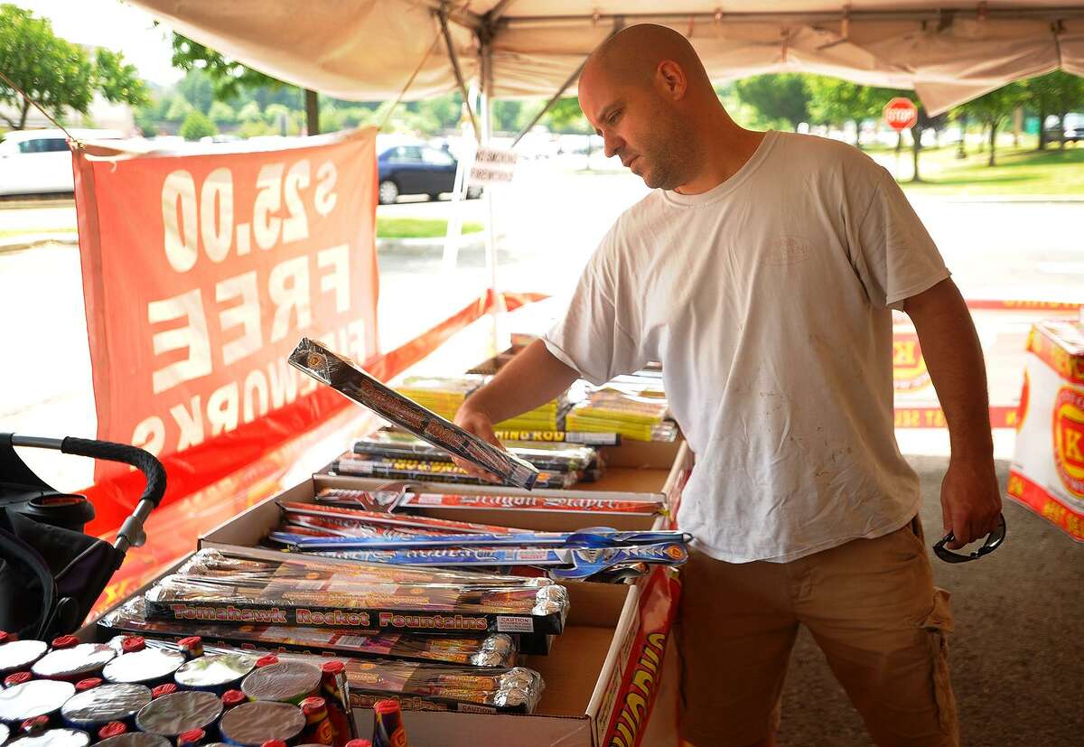 Jason Faucher, of Monroe, shops for fireworks for the 4th of July holiday at the Keystone Fireworks tent at the Connecticut Post Mall in Milford, Conn. on Tuesday, Julky 3, 2018.
