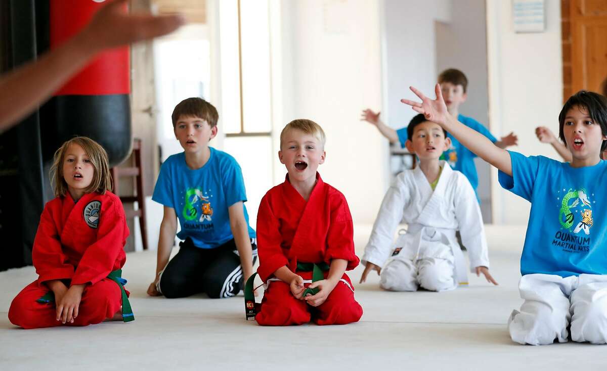 Bey Peters, 7, (center) joins other children in taking part in the Superhero Stunts & Martial Arts Camp at Quantum Martial Arts in the Mission District of San Francisco, Calif. on Thursday, June 28, 2018.
