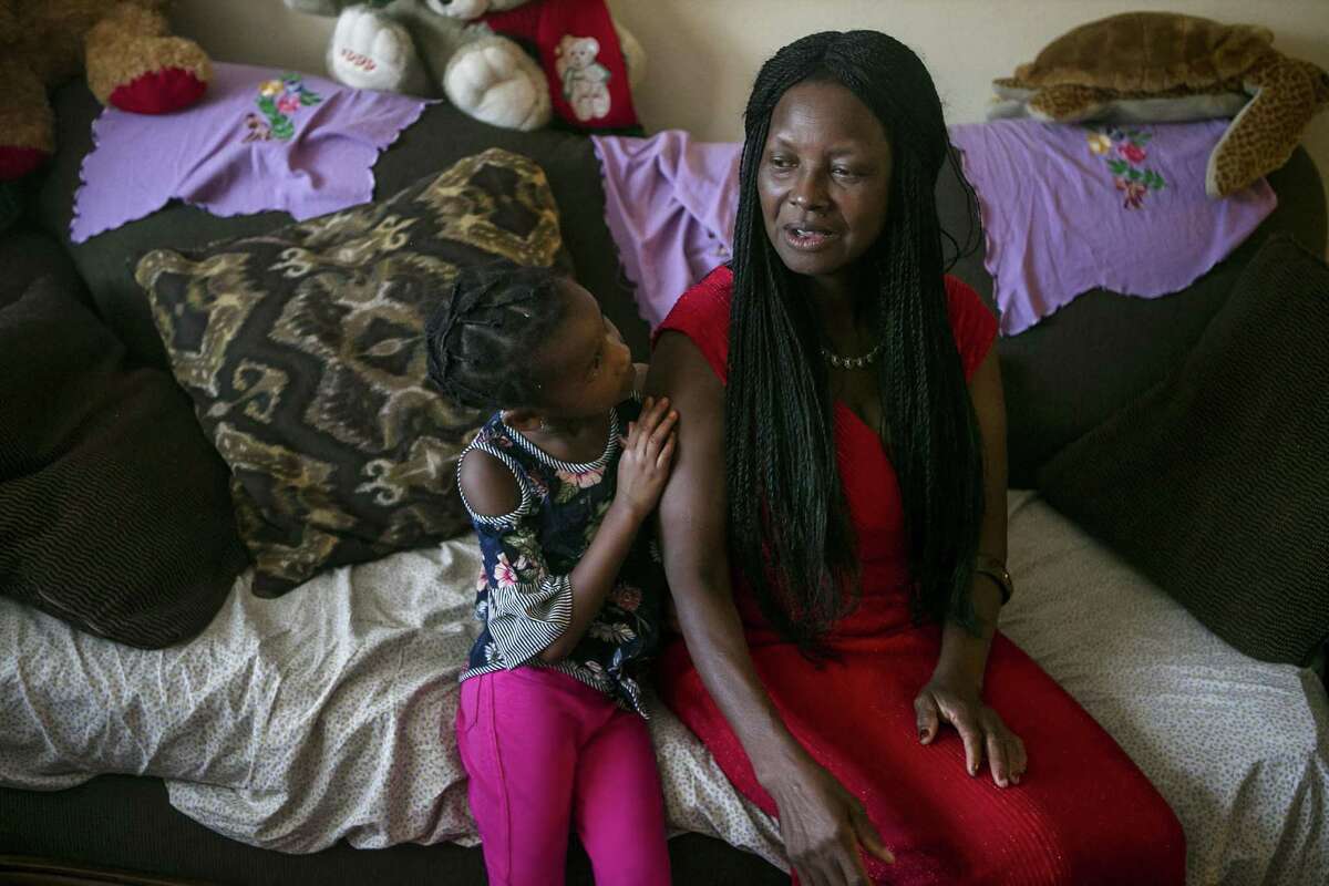 Josephine Toundamje talks about her and her family's journey to America from Chad as her grand daughter Jasmine Dilla, 4, listens at Toddamds San Antonio apartment June 27, 2018. Toddamds was happy to learn that her country Chad had been removed from President Trump's travel restriction list, but she still feels sad that the Supreme Court upheld the administration's travel ban against several Muslim majority countries.