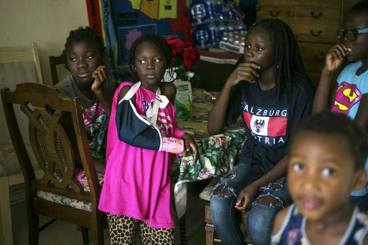 From left, Linette Mariamad, 12, Christel Djenemaji, 7, Pelagie Djeola, 14, and Darline Ndjenomgotto, 9, sit around their grandmother, Josephine Toundamje’s San Antonio apartment June 27, 2018. Toddamds was happy to learn that her country Chad had been removed from President Trump's travel restriction list, but she still feels sad that the Supreme Court upheld the administration's travel ban against several Muslim majority countries.