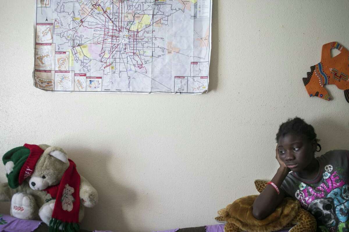 Linette Mariamad, 12, lounges in her grandmother, Josephine Toundamje’s San Antonio apartment June 27, 2018.