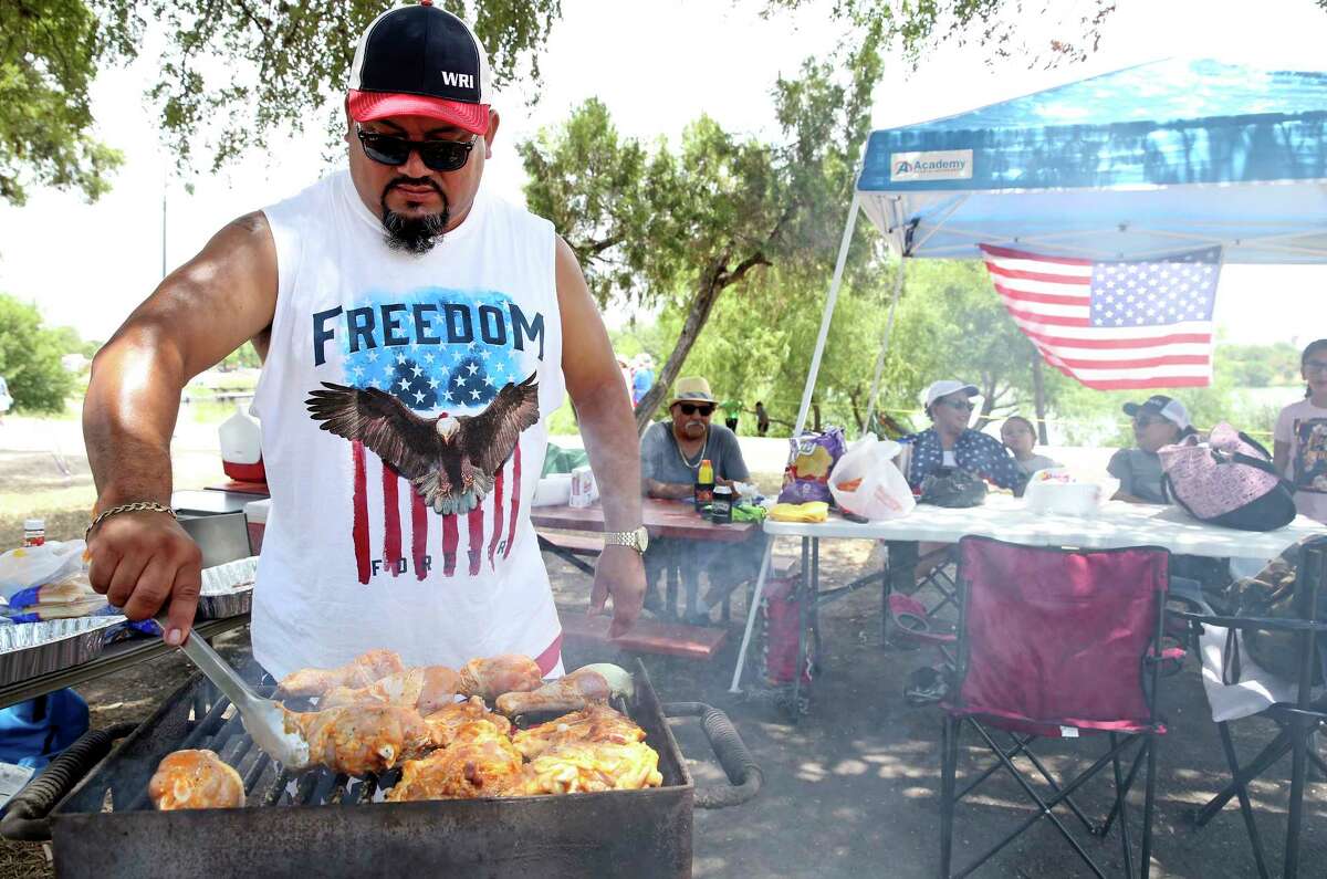George Lopez starts the grilling for his family at the City's official Fourth of July celebration at Woodlawn Lake on July 4, 2018.