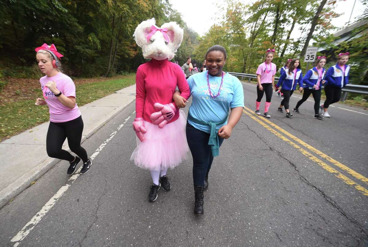 Walkers and runners begin the Pounding the Pavement for Pink 5K walk and run in Seymour on October 7, 2017.