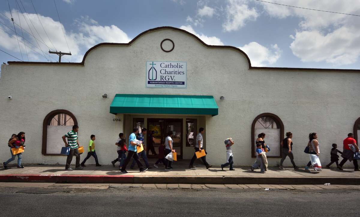 June 29, 2018 - McAllen, Texas - Newly released immigrants dropped off at Central bus station are met by a volunteer and walk to Catholic Charities of the Rio Grande Valley (CCRGV) with the help of the Sacred Heart Church, the City of McAllen, which serves as a humanitarian respite center after immigrants are processed and released. They are given food, clothes, shoelaces which were taken from them, medical attention and welcoming warmth. Carol Guzy/ for San Antonio Express-News