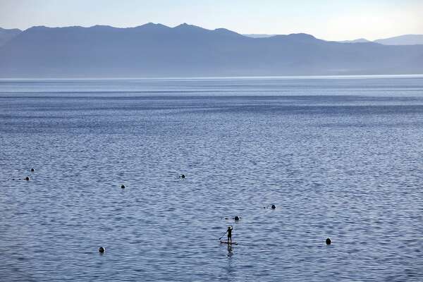 a stand up paddle boarder is seen in lake tahoe on october 3